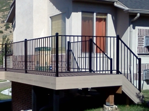 An ornamental iron railing on deck and stairs