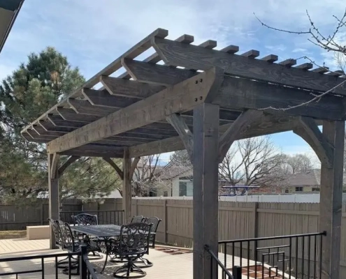 A beautifully stained pergola over an outdoor living space
