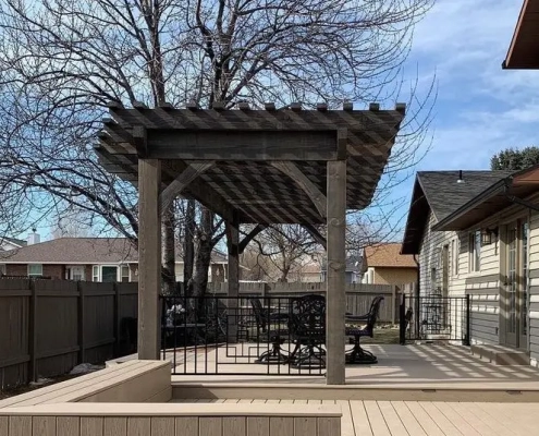A wood pergola with shade planks on top